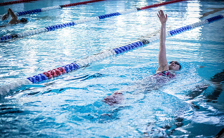 Adult swimming in pool