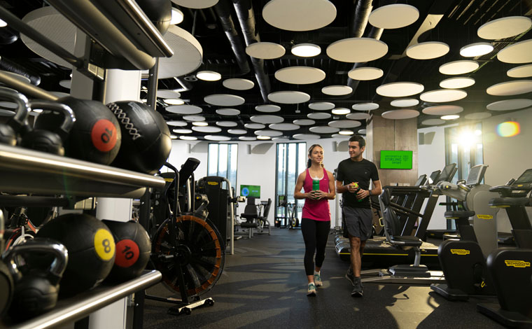 two students walking in gym