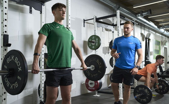 personal trainer in weights room