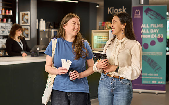 A pair of happy students with their tickets at Macrobert Arts Centre